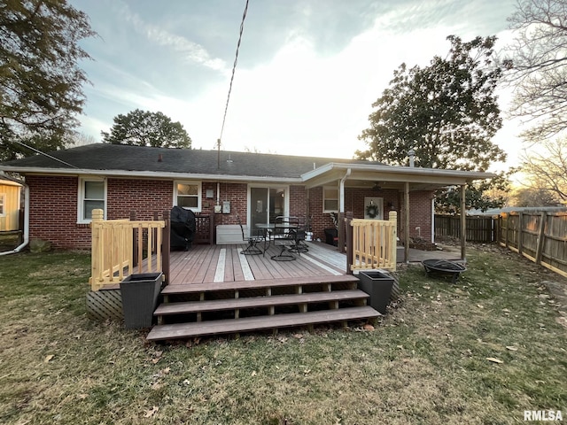 back of house with a wooden deck and a lawn