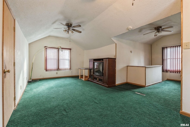 additional living space with lofted ceiling, carpet flooring, a textured ceiling, and ceiling fan