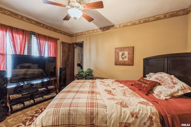 bedroom with parquet floors and ceiling fan