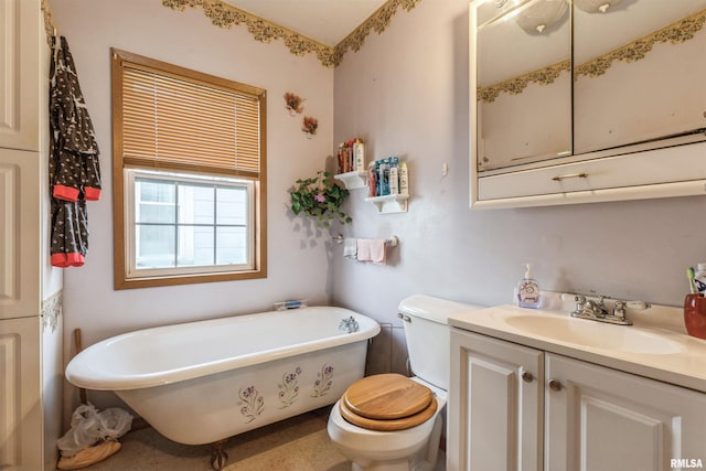 bathroom featuring vanity, toilet, and a tub