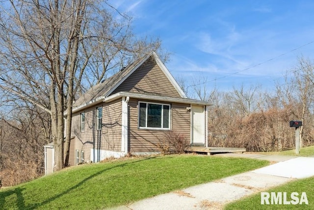 view of property exterior with a yard