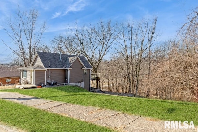 view of side of home featuring a lawn