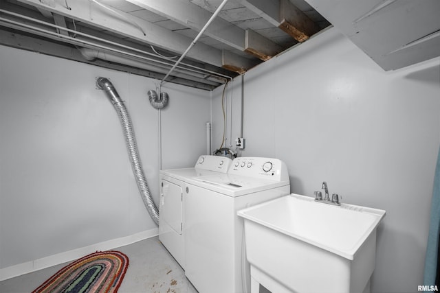 clothes washing area featuring sink and independent washer and dryer