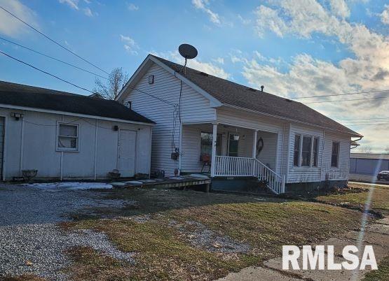 view of front of property with a front yard and covered porch