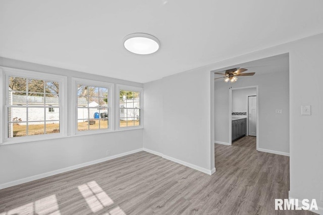 spare room with light hardwood / wood-style flooring and ceiling fan