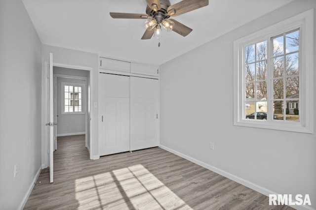 unfurnished bedroom with a closet, ceiling fan, and light hardwood / wood-style flooring