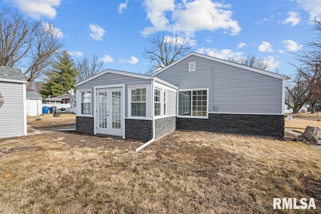 rear view of house with a yard and french doors