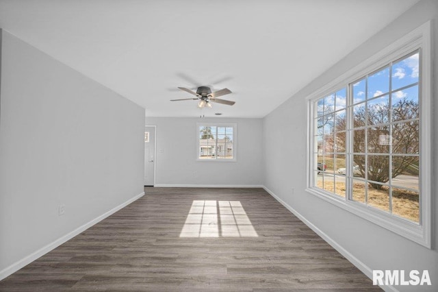 unfurnished room with ceiling fan and dark hardwood / wood-style flooring