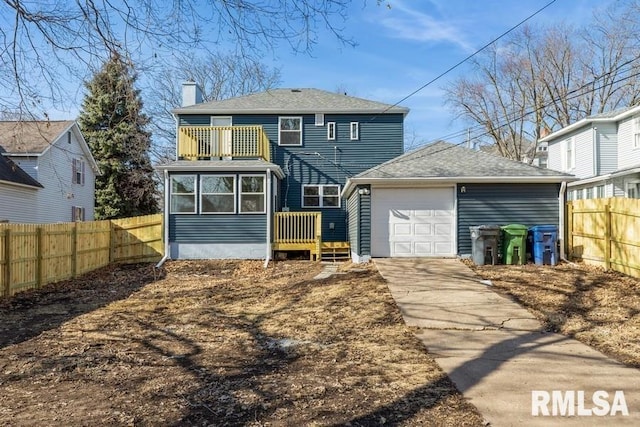 back of property with a garage, an outdoor structure, a sunroom, and a balcony