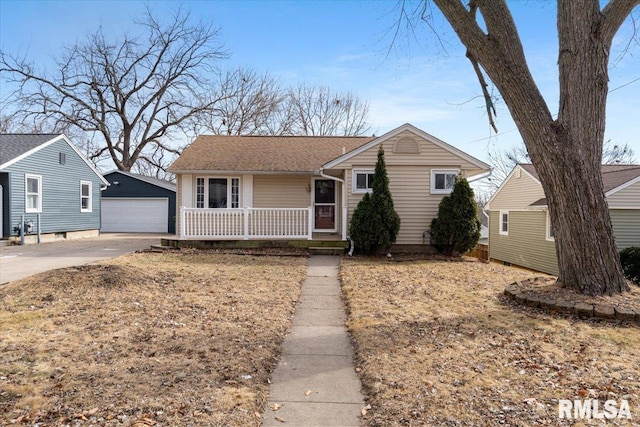 view of front of property with a porch, a garage, and an outdoor structure