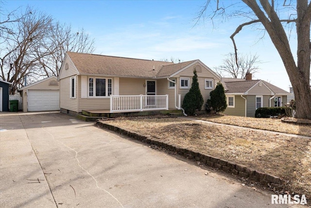 ranch-style house featuring a garage and an outbuilding