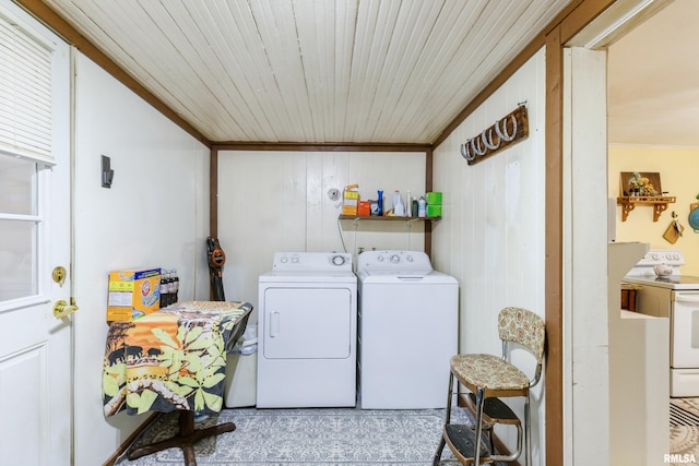 laundry area featuring ornamental molding and washing machine and dryer