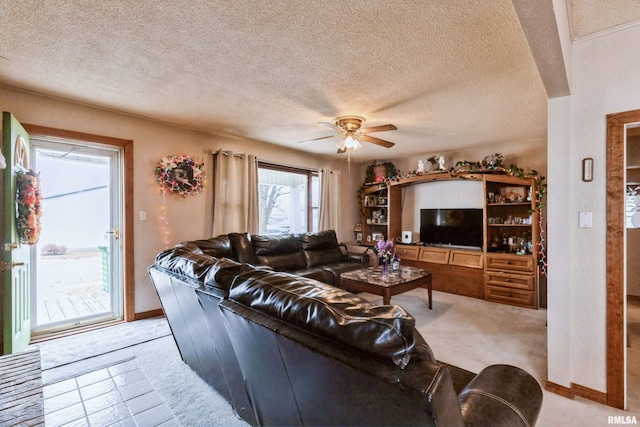 living room featuring ceiling fan and a textured ceiling