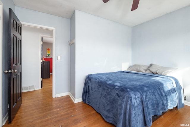 bedroom with dark wood-type flooring and ceiling fan