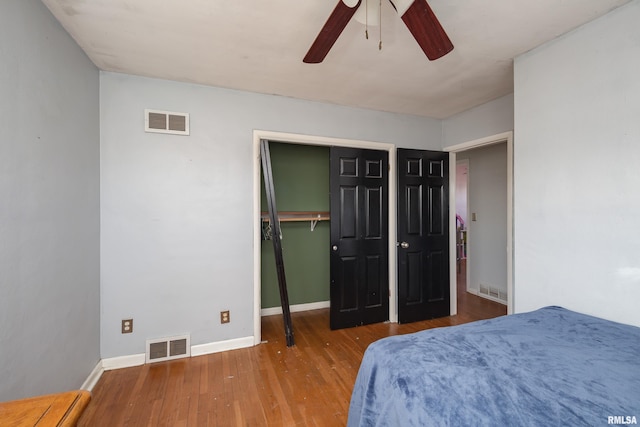 bedroom featuring wood-type flooring, a closet, and ceiling fan