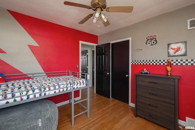 bedroom with ceiling fan and light wood-type flooring