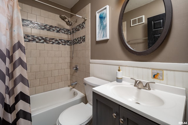 full bathroom with vanity, shower / bath combination with curtain, and toilet