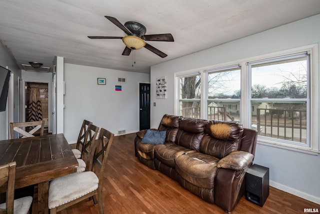 living room with dark hardwood / wood-style floors and ceiling fan