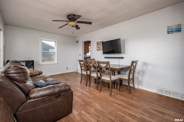 living room with hardwood / wood-style flooring and ceiling fan