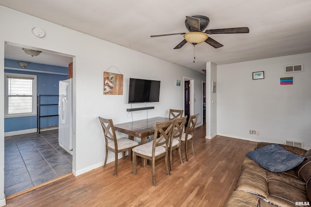 dining room featuring dark hardwood / wood-style floors and ceiling fan