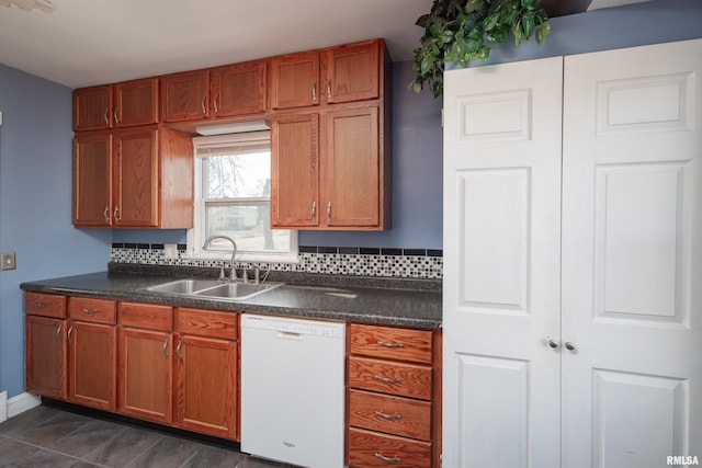 kitchen featuring tasteful backsplash, white dishwasher, and sink