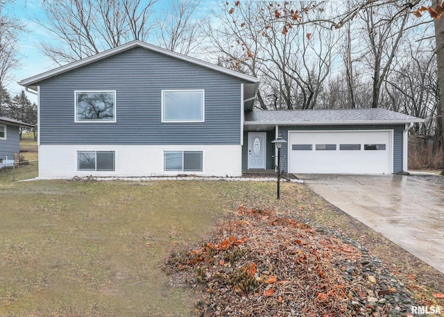 tri-level home featuring a garage and a front yard