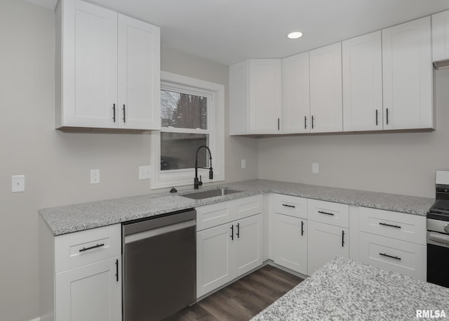 kitchen featuring stainless steel appliances, light stone countertops, sink, and white cabinets