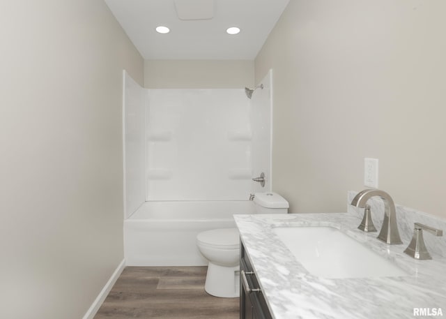 full bathroom featuring hardwood / wood-style flooring, vanity, toilet, and shower / bathing tub combination