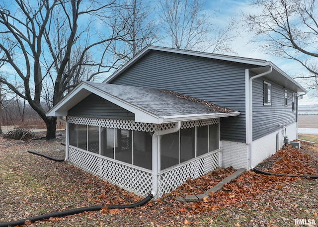 view of home's exterior with a sunroom