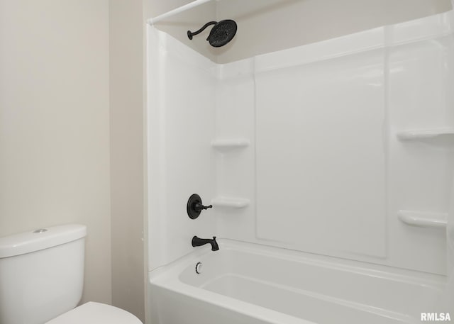 bathroom featuring tub / shower combination and toilet