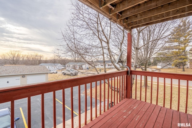 deck at dusk featuring a garage