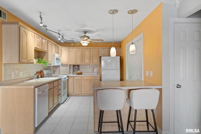 kitchen with light tile patterned floors, white appliances, ceiling fan, decorative backsplash, and light brown cabinets