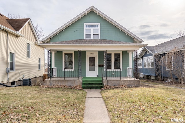 bungalow-style home featuring central AC, a front yard, and covered porch