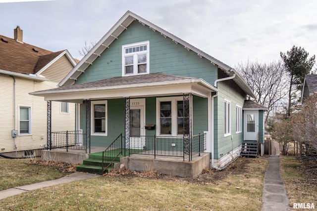 bungalow-style house with a porch and a front yard