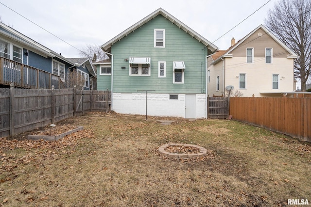 rear view of house featuring a lawn