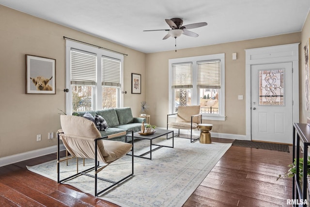 living room with ceiling fan, dark hardwood / wood-style flooring, and a wealth of natural light