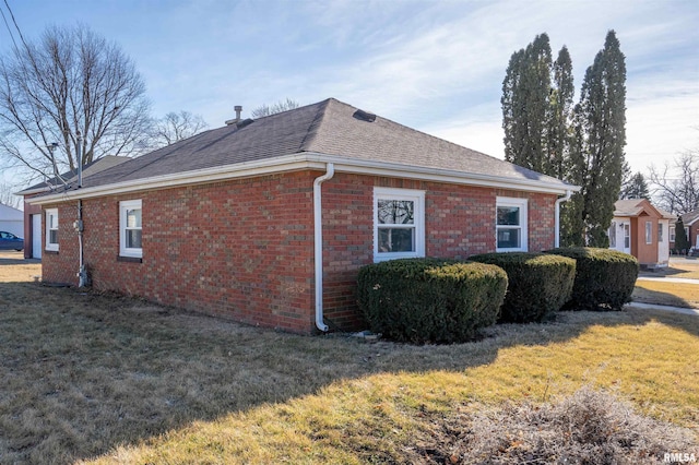 view of side of property featuring a yard