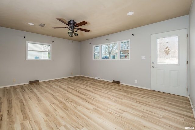 foyer with ceiling fan, a healthy amount of sunlight, and light hardwood / wood-style floors