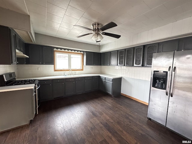 kitchen with sink, decorative backsplash, dark wood-type flooring, and stainless steel appliances