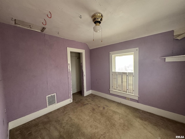 empty room with lofted ceiling and carpet