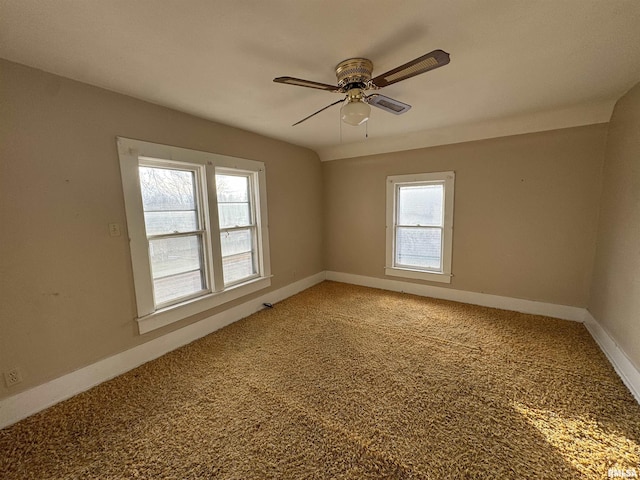 carpeted spare room with ceiling fan