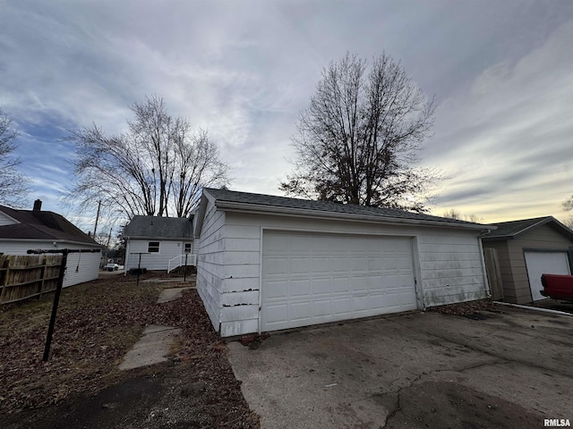 view of garage at dusk