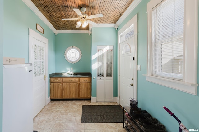 entryway with wood ceiling, ceiling fan, and ornamental molding