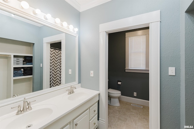 bathroom with tile patterned flooring, vanity, ornamental molding, and toilet