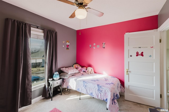 bedroom featuring ceiling fan and light carpet