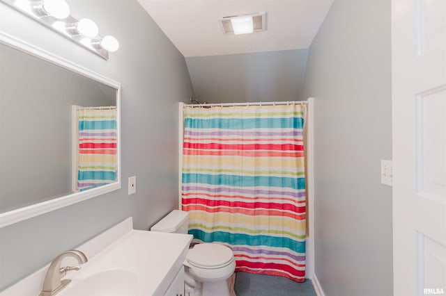 bathroom with vanity, curtained shower, vaulted ceiling, and toilet