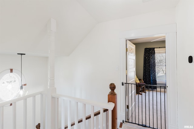 hall with lofted ceiling and carpet