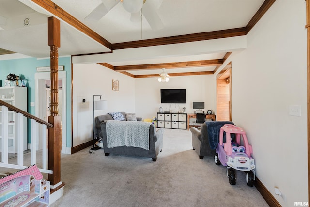 carpeted bedroom with beamed ceiling, ornamental molding, and ceiling fan