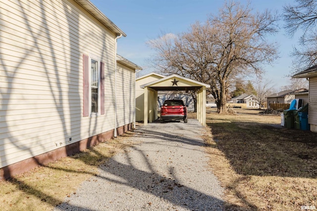 view of side of home with a carport