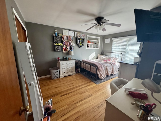 bedroom with light hardwood / wood-style floors and ceiling fan